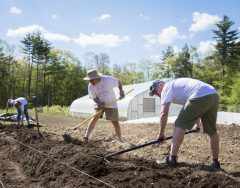 Joining other staff and students, President Dlugos (center) works the soil at the College’s farm for the Beth Auger Day of Service last year.