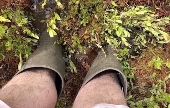 Dylan Fry looks down at his muddy boots