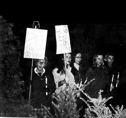 SJC students hold signs saying “Stop the War” and “Peace” during a vigil in the 1969-70 school year.