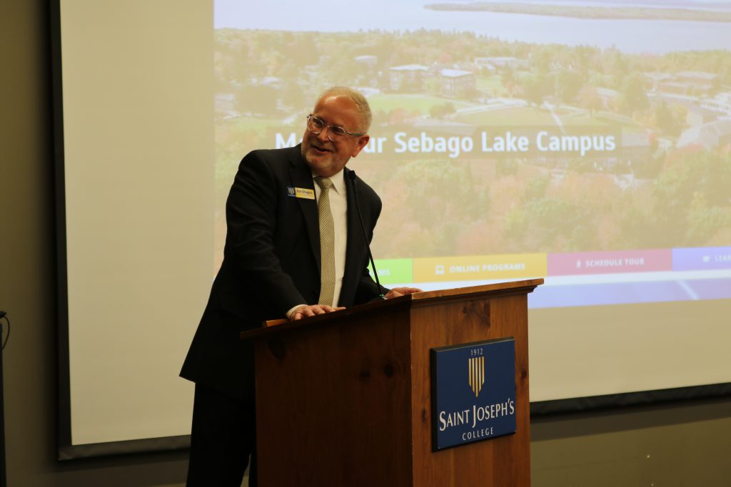 President James Dlugos speaks at Saint Joseph's College of Maine event. 