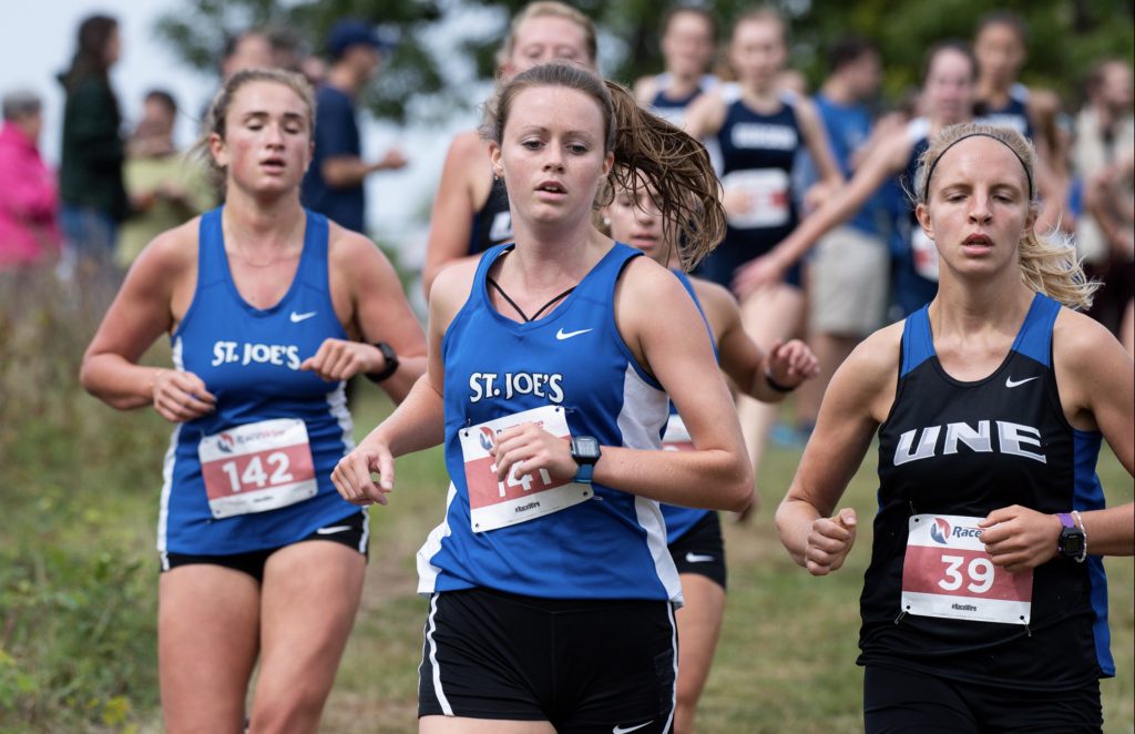Sarah Curtin and runners in an SJC cross country race.