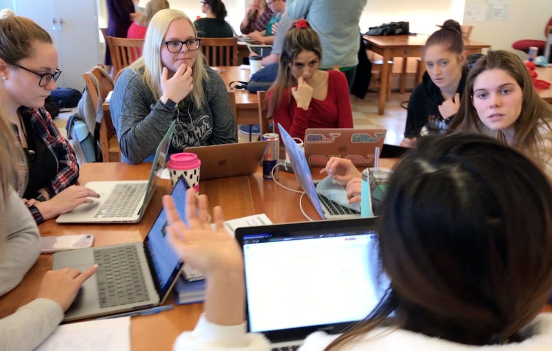 elementary education students sit at table for a discussion