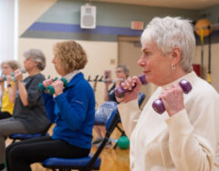 SilverSneakers fitness class participants holding hand weights