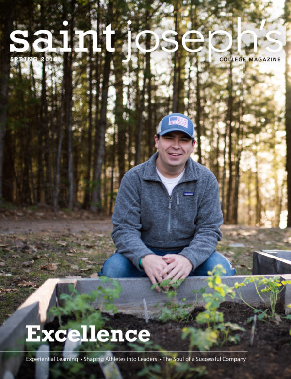Cover photo of the Spring 2019 Saint Joseph's College of Maine magazine - showing Caleb Gravel at the Pollinator Garden